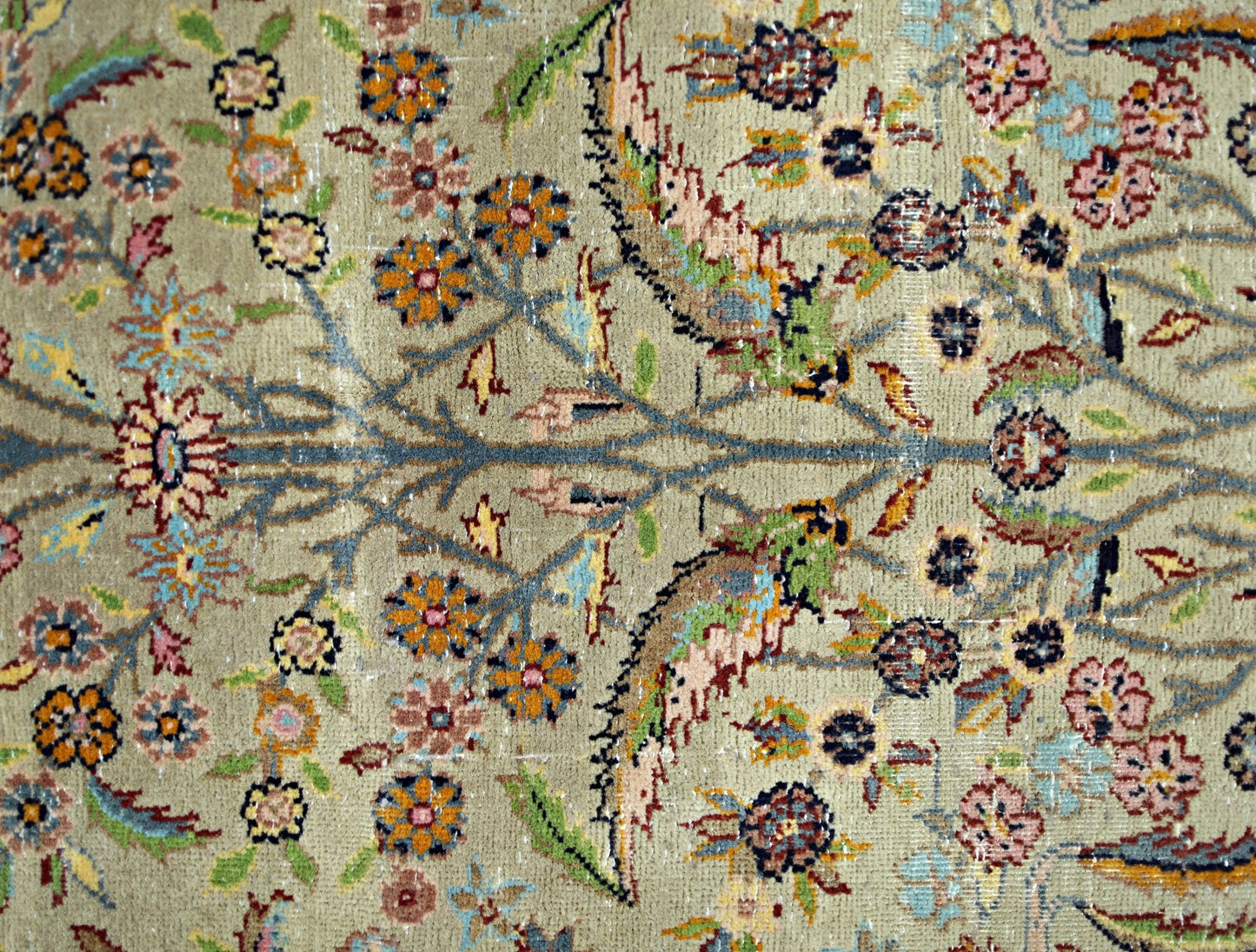 A vintage Persian prayer rug featuring a detailed floral pattern in muted tones on a wool pile.