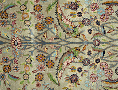 A vintage Persian prayer rug featuring a detailed floral pattern in muted tones on a wool pile.