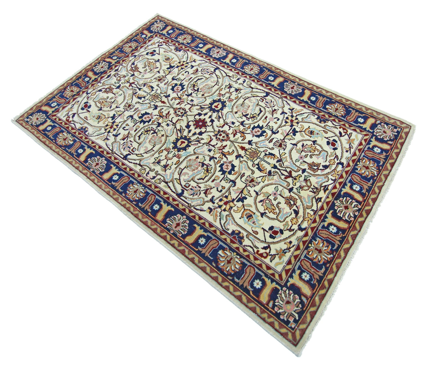 A vintage Pakistani rug featuring a cream field with intricate floral patterns and a blue border.