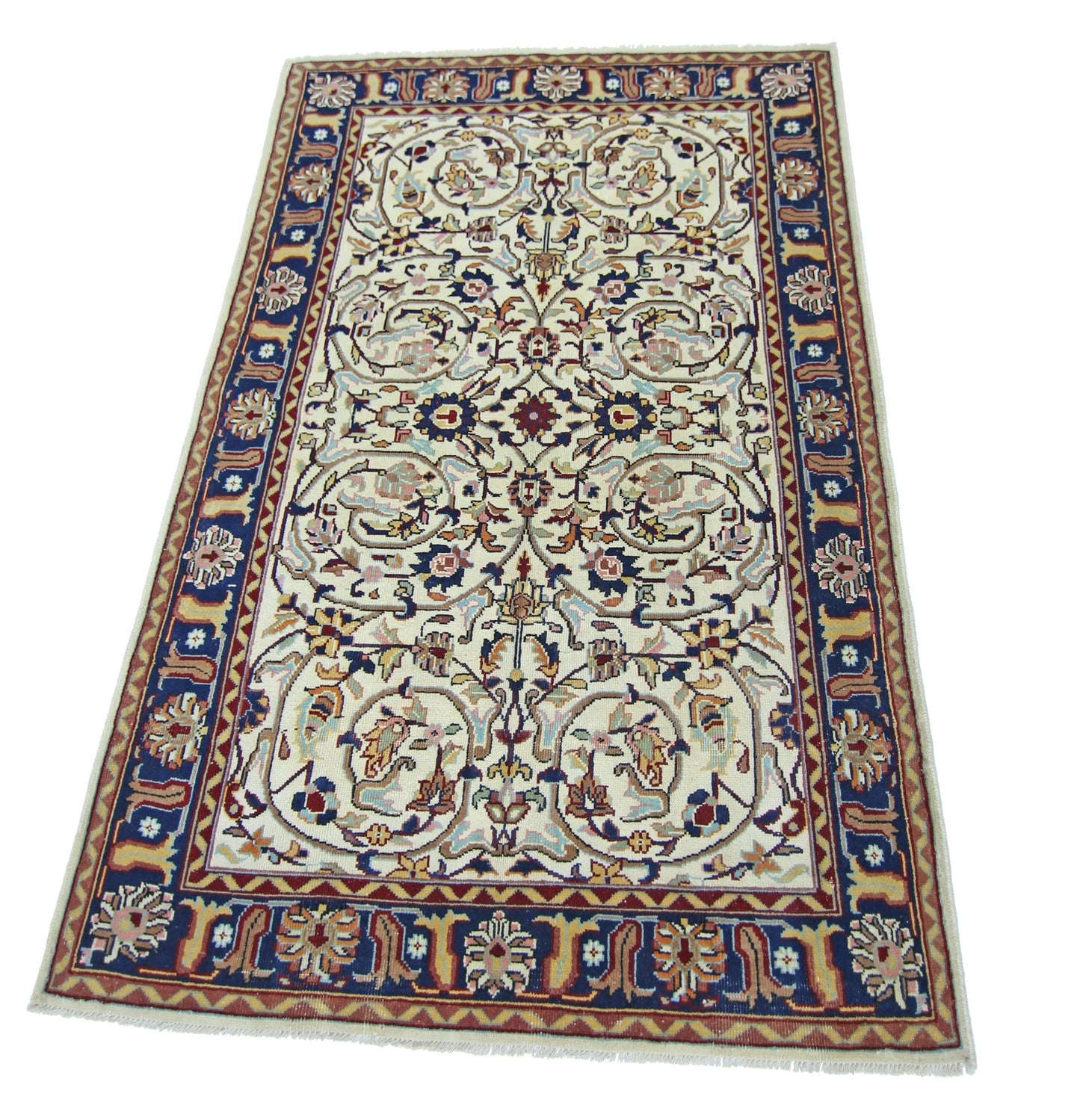 A vintage Pakistani rug featuring an intricate floral pattern in blue, red, and cream tones.