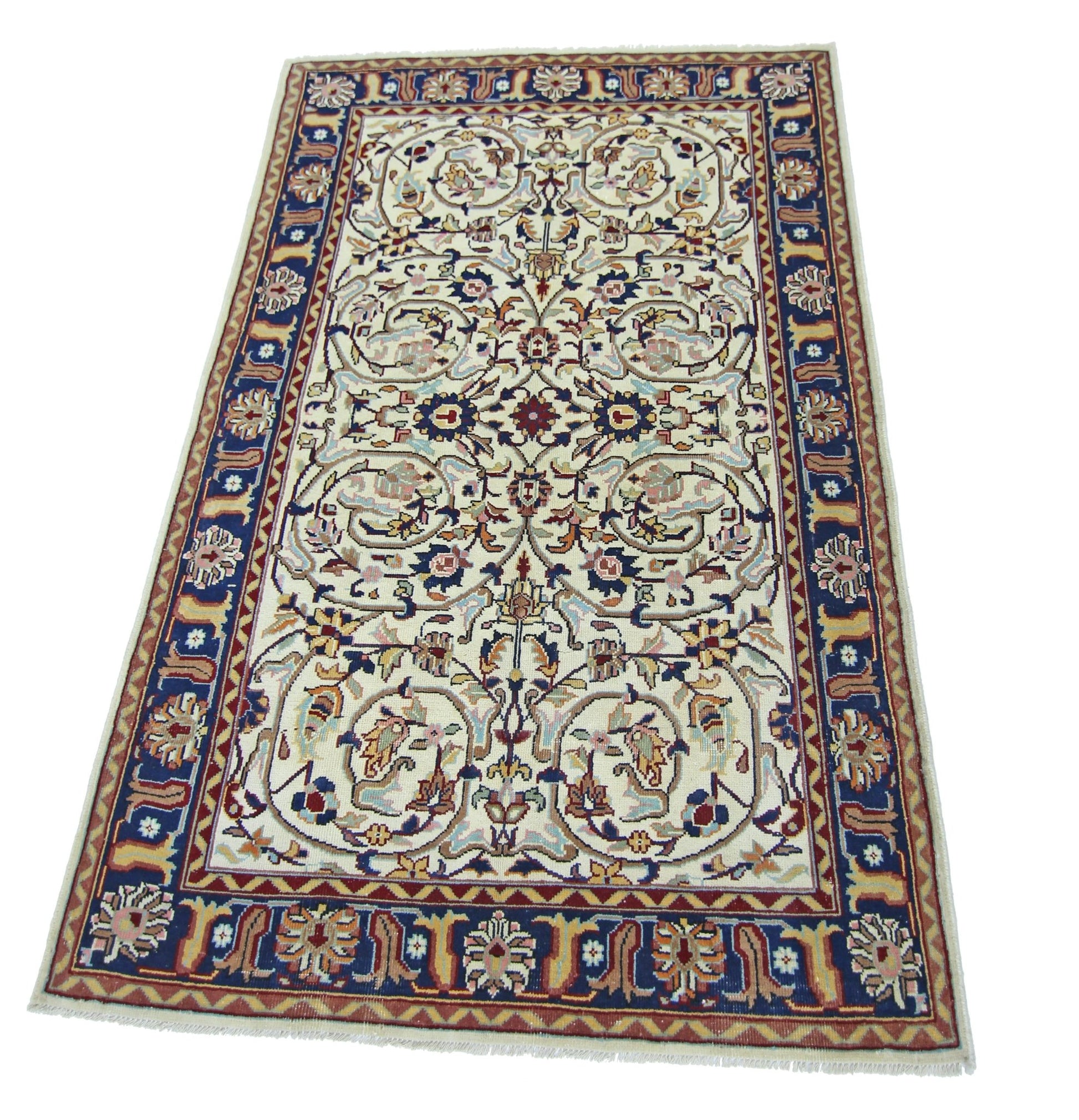 A vintage Pakistani rug featuring an intricate floral pattern in blue, red, and cream tones.