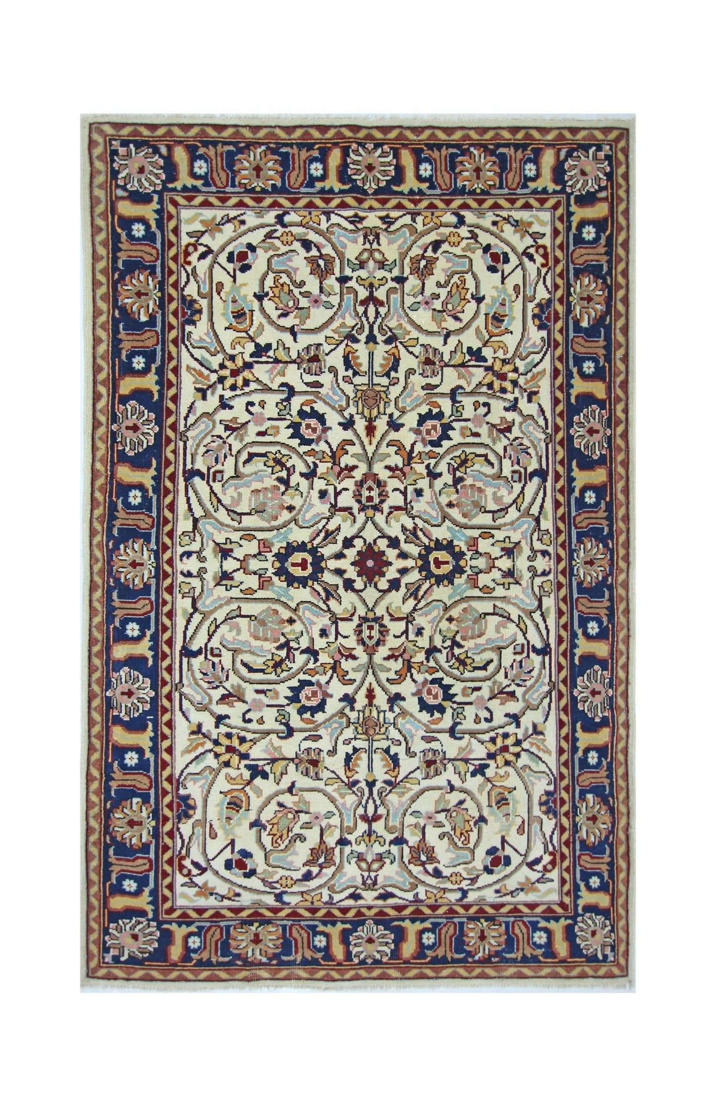 A vintage Pakistani rug featuring a cream field with intricate floral patterns and a blue border.