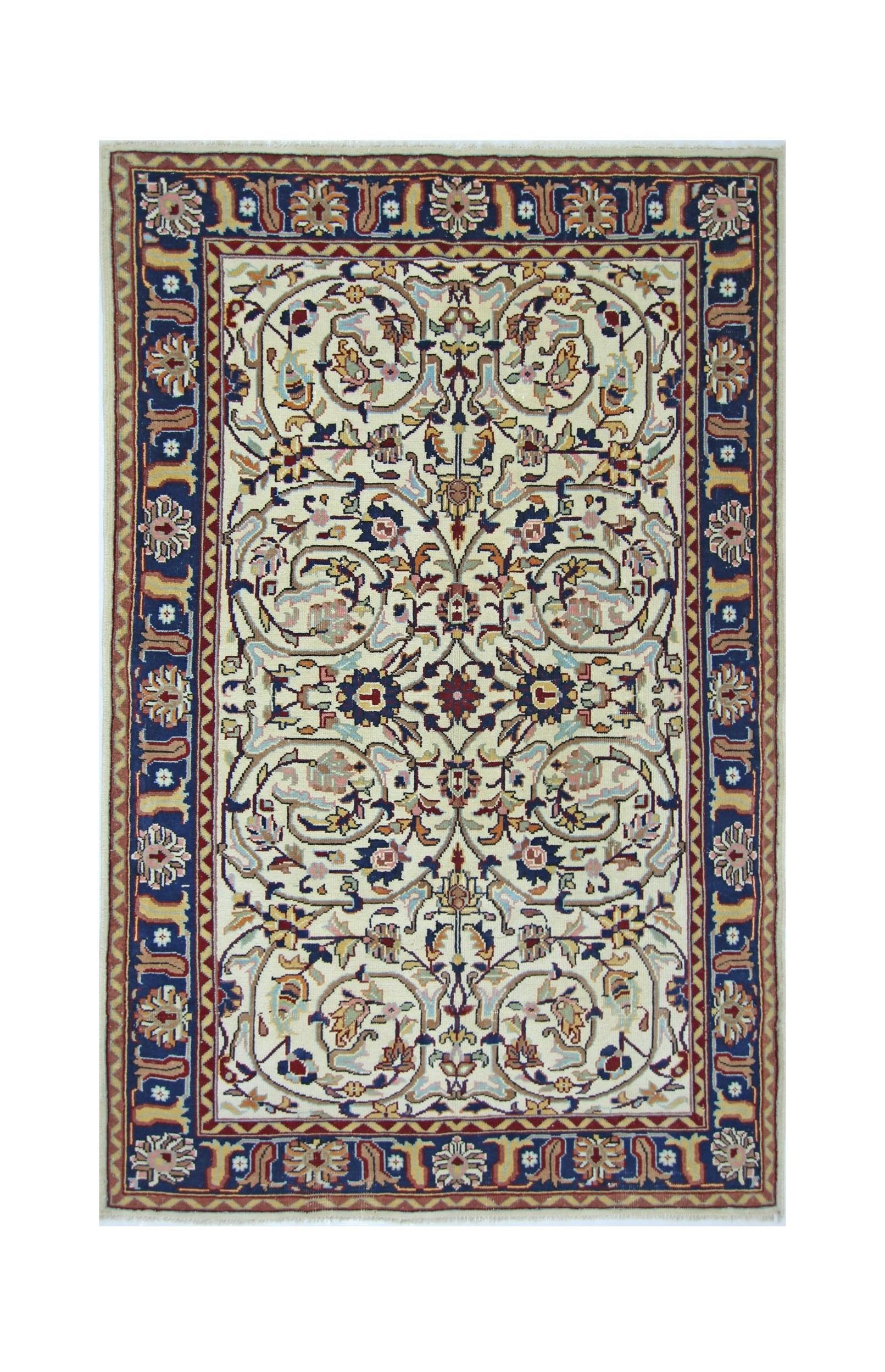 A vintage Pakistani rug featuring a cream field with intricate floral patterns and a blue border.