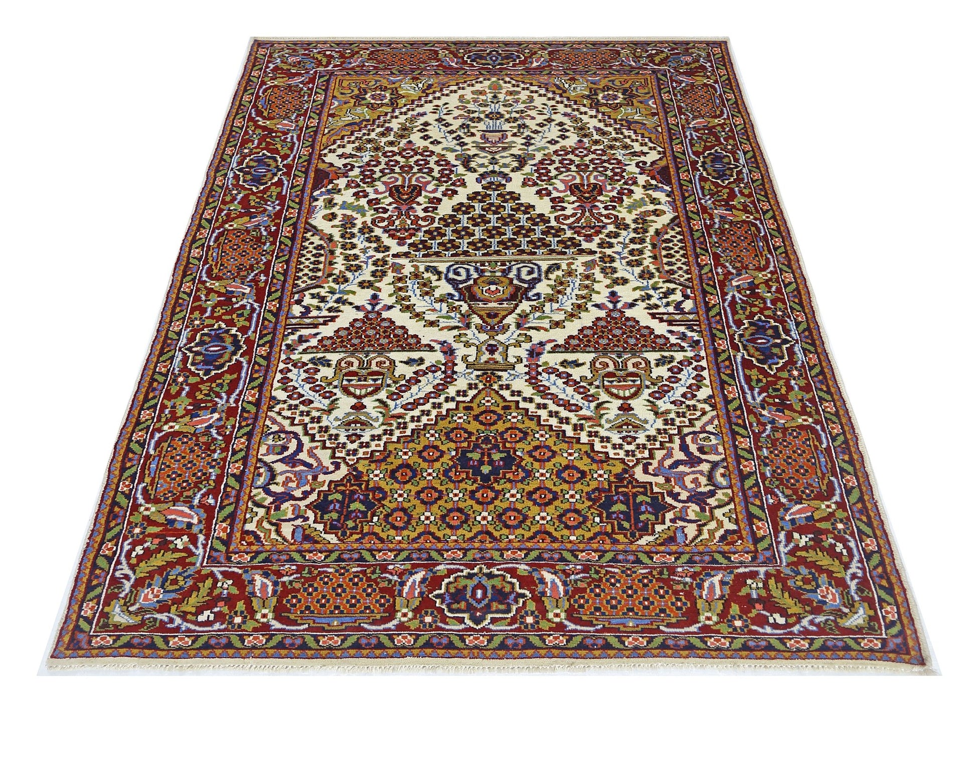 A rectangular vintage Pakistani rug featuring a traditional floral pattern in red and cream tones.
