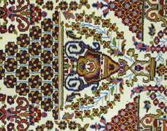A vintage Pakistani wool rug featuring a detailed floral pattern in red, blue, and gold tones.