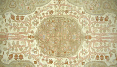 A vintage Pakistani rug featuring a central medallion with intricate floral patterns in muted tones.