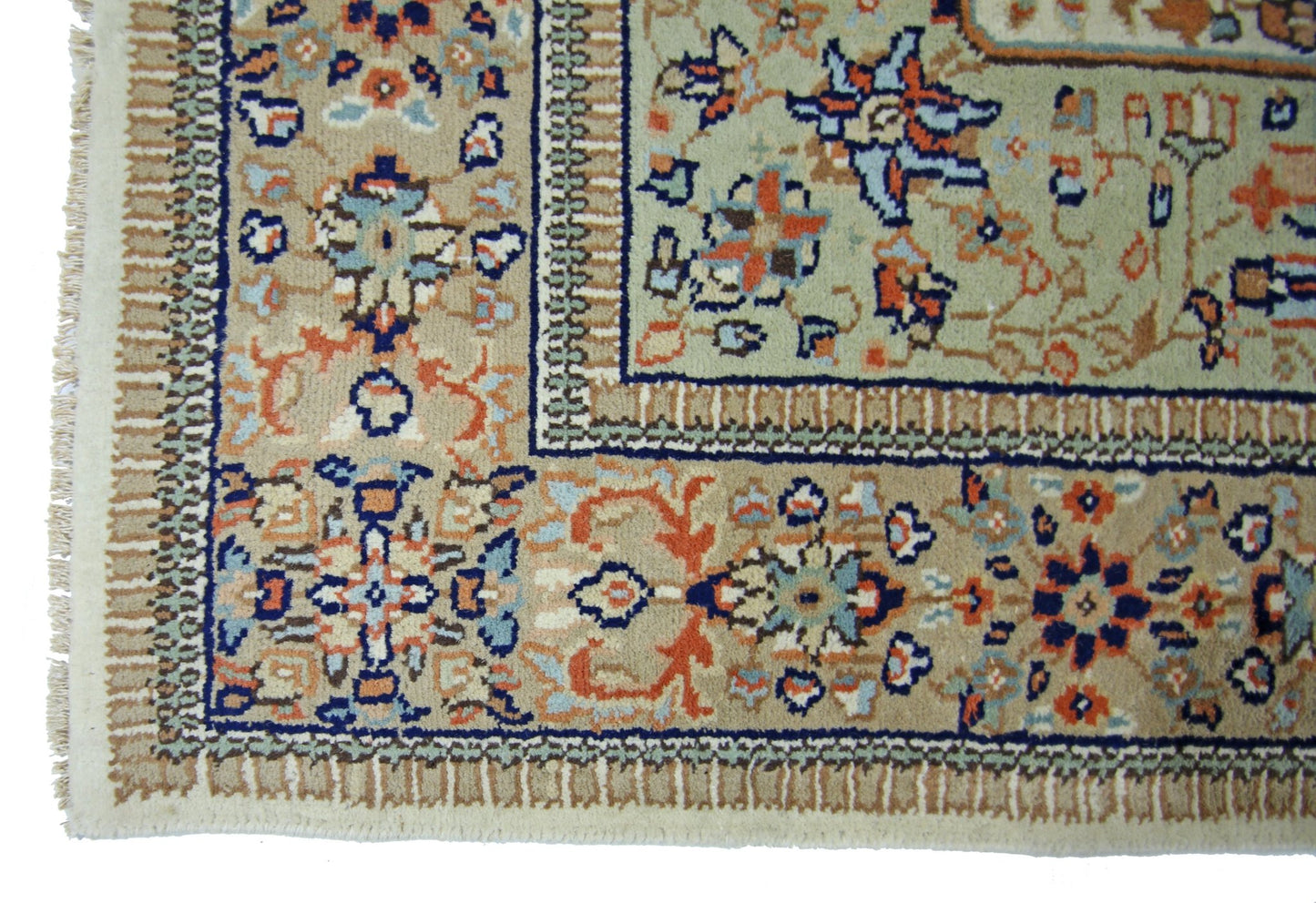 A vintage Pakistani rug featuring intricate floral patterns in blue, orange, and beige tones.