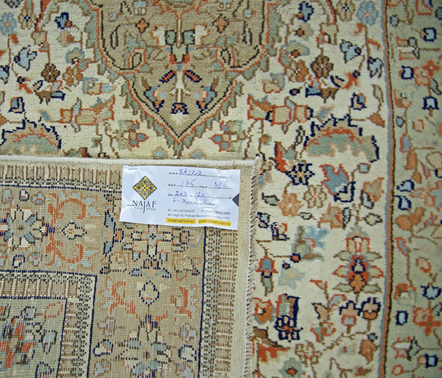 A vintage Pakistani rug featuring a traditional floral pattern in soft blue and orange tones.