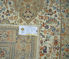 A vintage Pakistani rug featuring a traditional floral pattern in soft blue and orange tones.