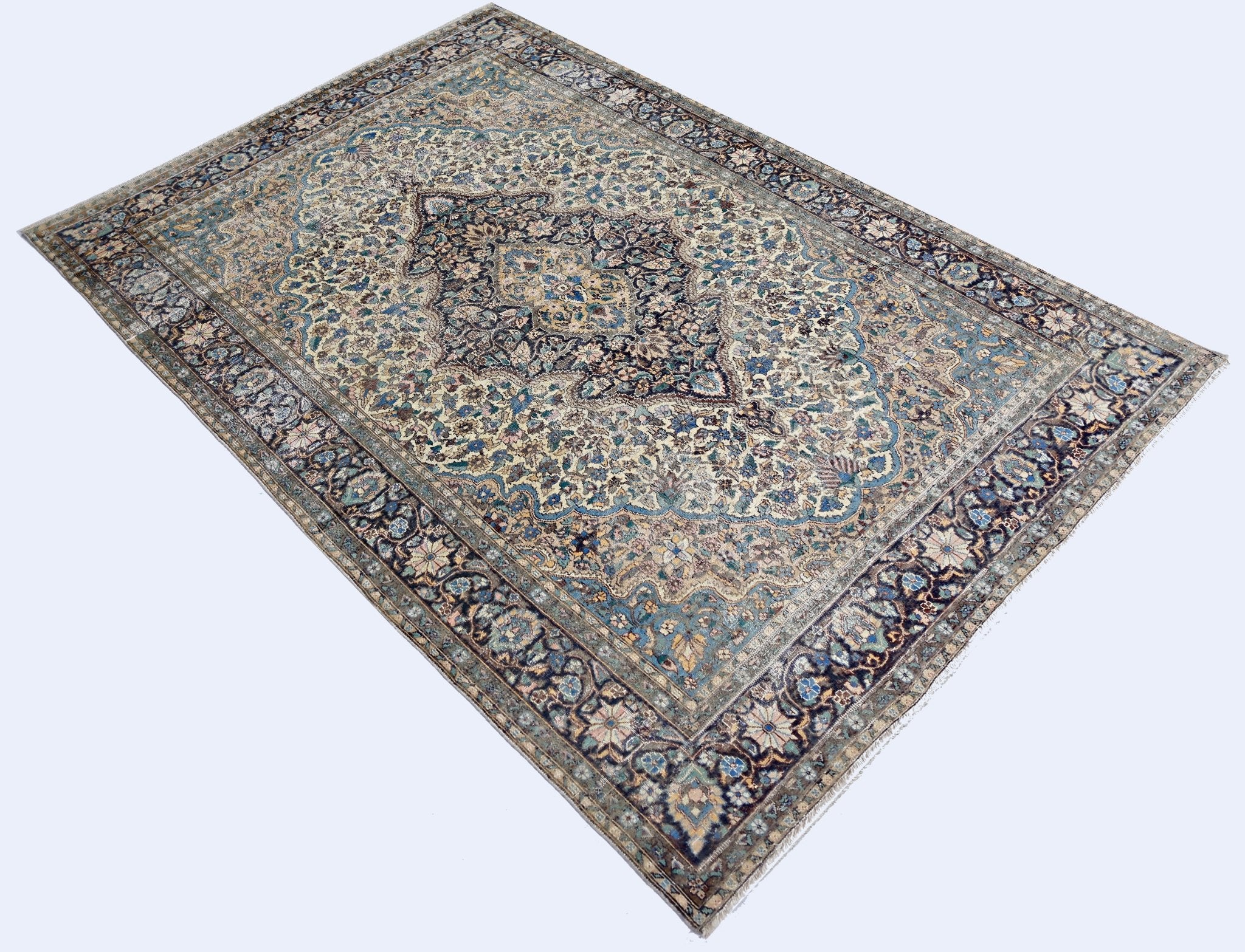 A vintage Pakistani rug featuring an intricate floral medallion design in blue and cream tones.