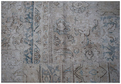A handmade vintage patchwork rug featuring faded floral patterns in shades of blue and beige.