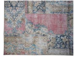 A handmade vintage patchwork rug featuring a mix of floral patterns in blue, pink, and beige tones.