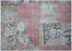 A vintage patchwork rug featuring a mix of floral and geometric patterns in faded pink and blue.