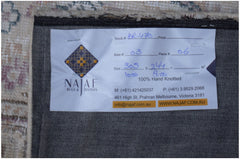 The underside of a vintage patchwork rug showing a Najaf Rugs and Textiles label.