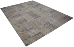 A rectangular handmade vintage patchwork rug featuring faded patterns in neutral earth tones.
