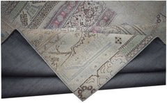 A vintage patchwork rug with a folded corner revealing its intricate floral and geometric patterns.