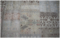 A handmade vintage patchwork rug featuring a variety of faded floral and geometric patterns.