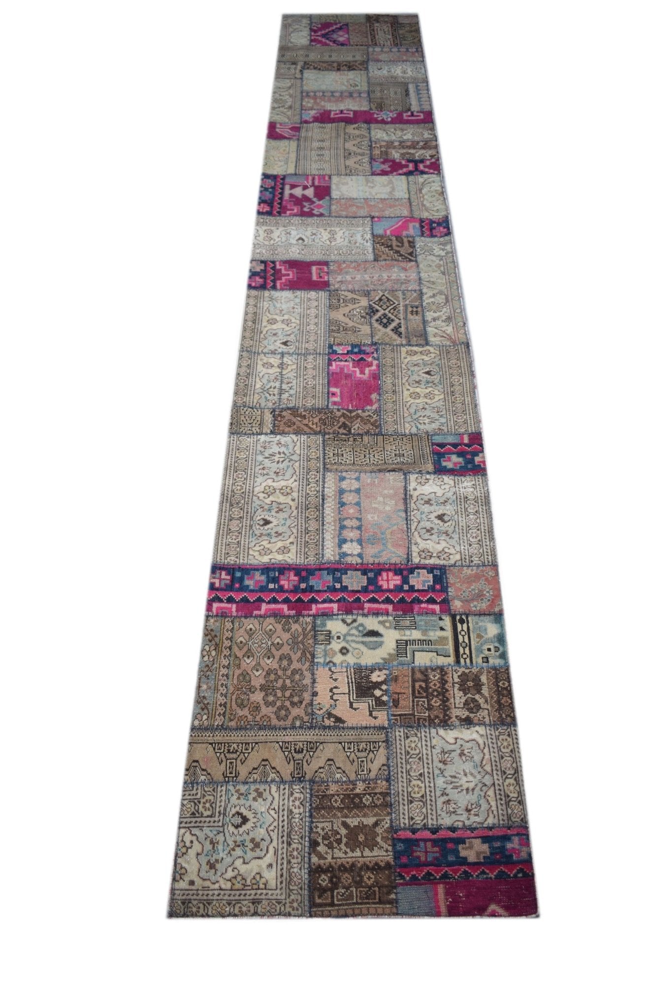 A handmade vintage patchwork runner rug featuring a colorful mix of wool patterns.