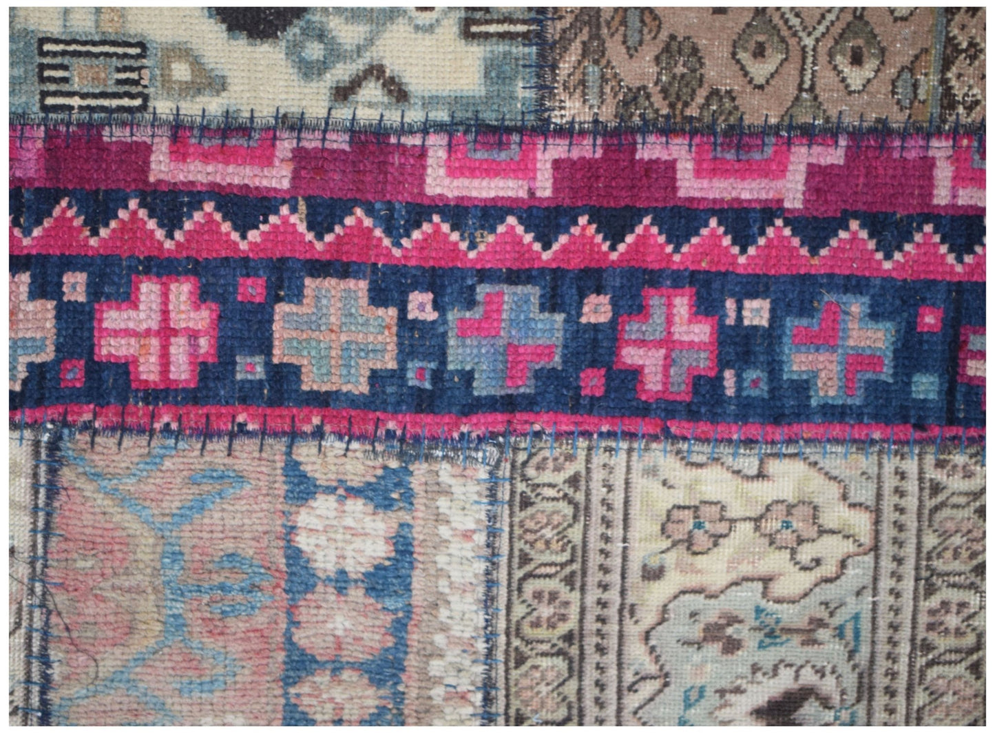 A handmade vintage patchwork runner featuring wool panels with geometric and floral patterns.