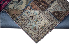 A handmade vintage patchwork runner featuring intricate wool patterns in muted earth tones.