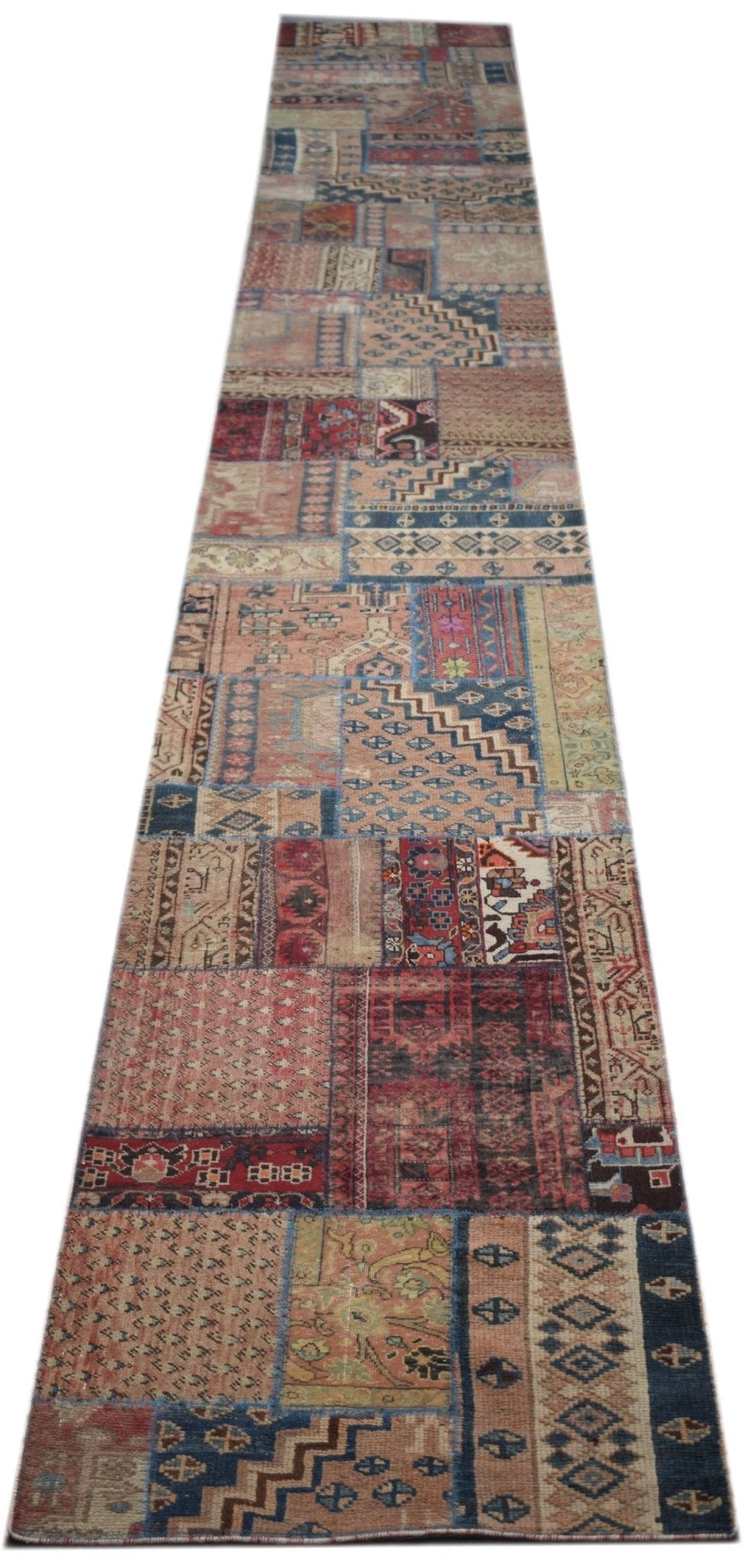 A handmade vintage patchwork runner rug featuring a variety of colorful, distressed wool patterns.