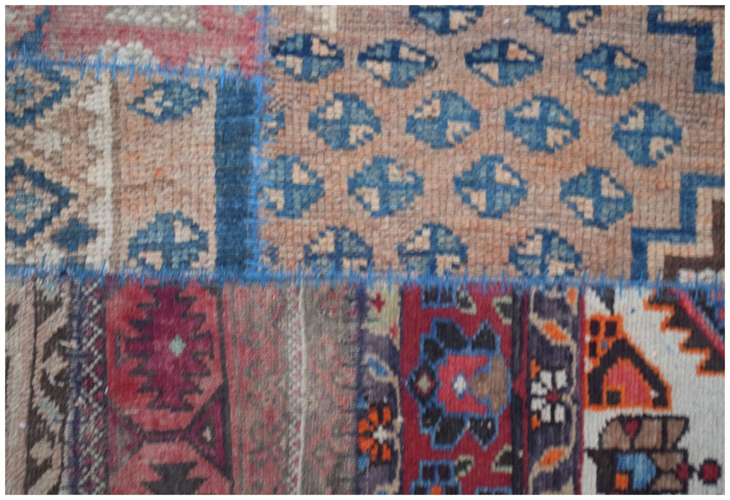 A handmade vintage patchwork runner featuring a variety of colorful wool rug fragments.