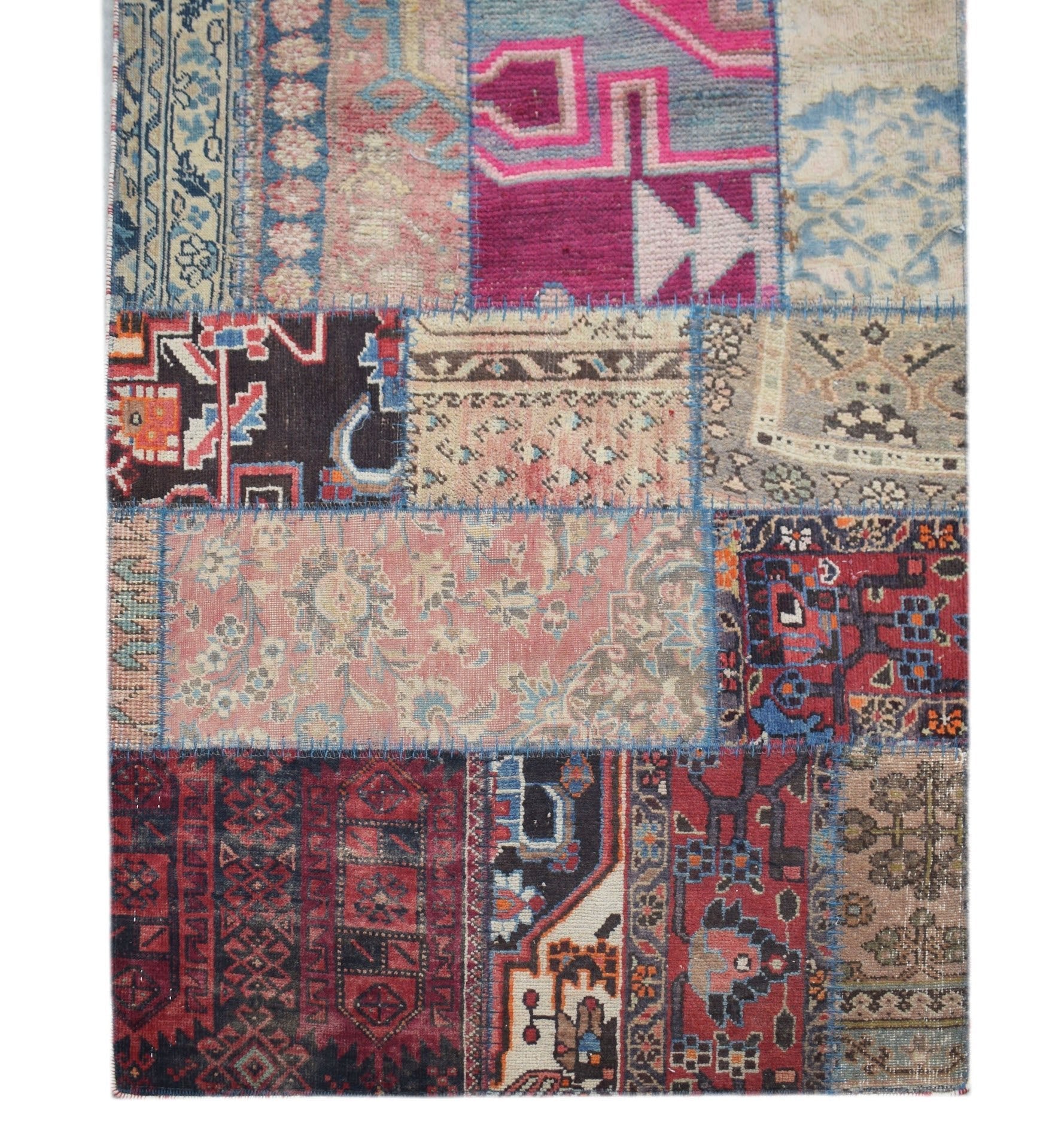 A handmade vintage patchwork runner featuring a vibrant mix of wool rug fragments in various colors.