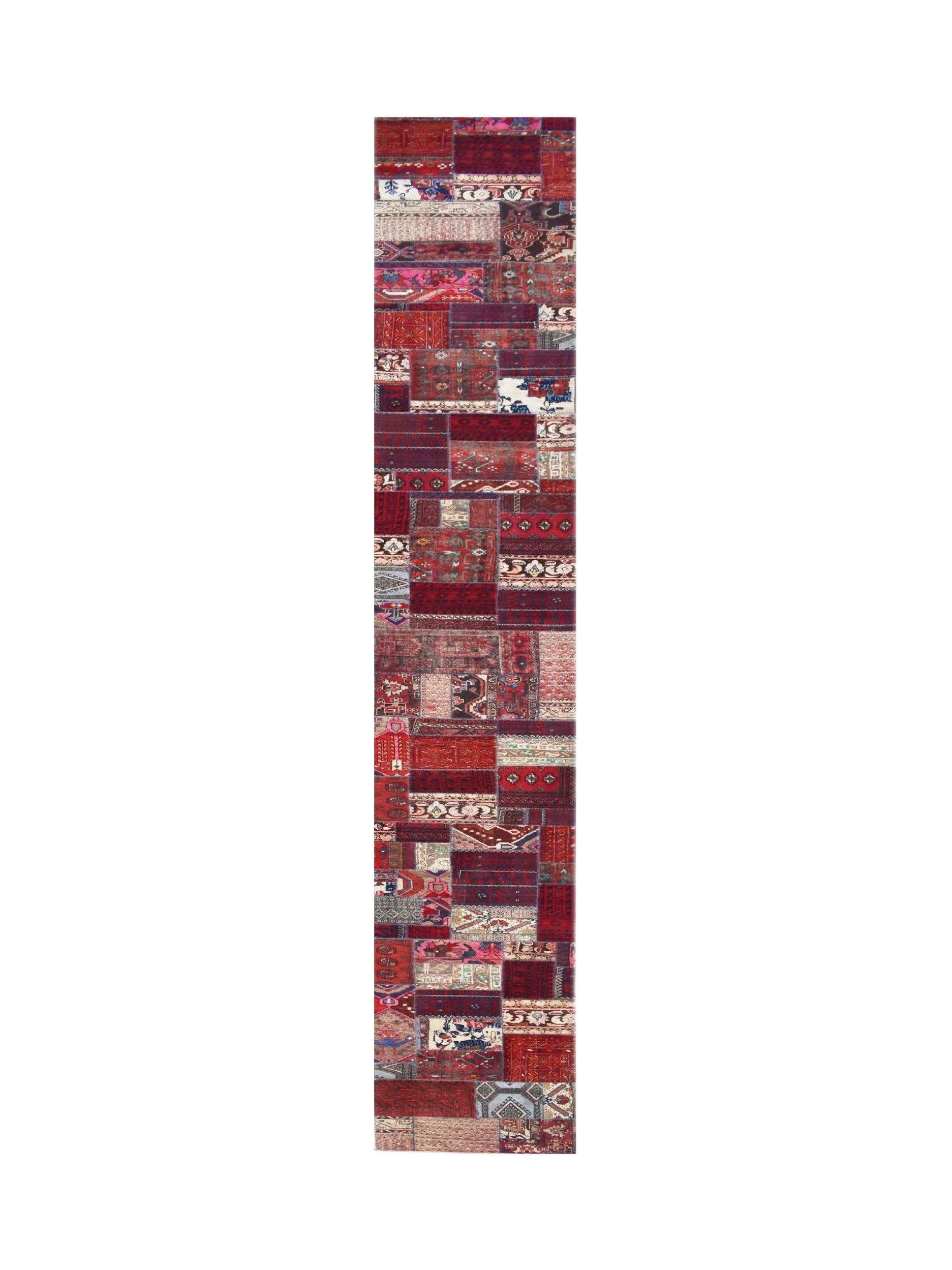 A handmade wool runner rug featuring a vintage patchwork design in various shades of red.