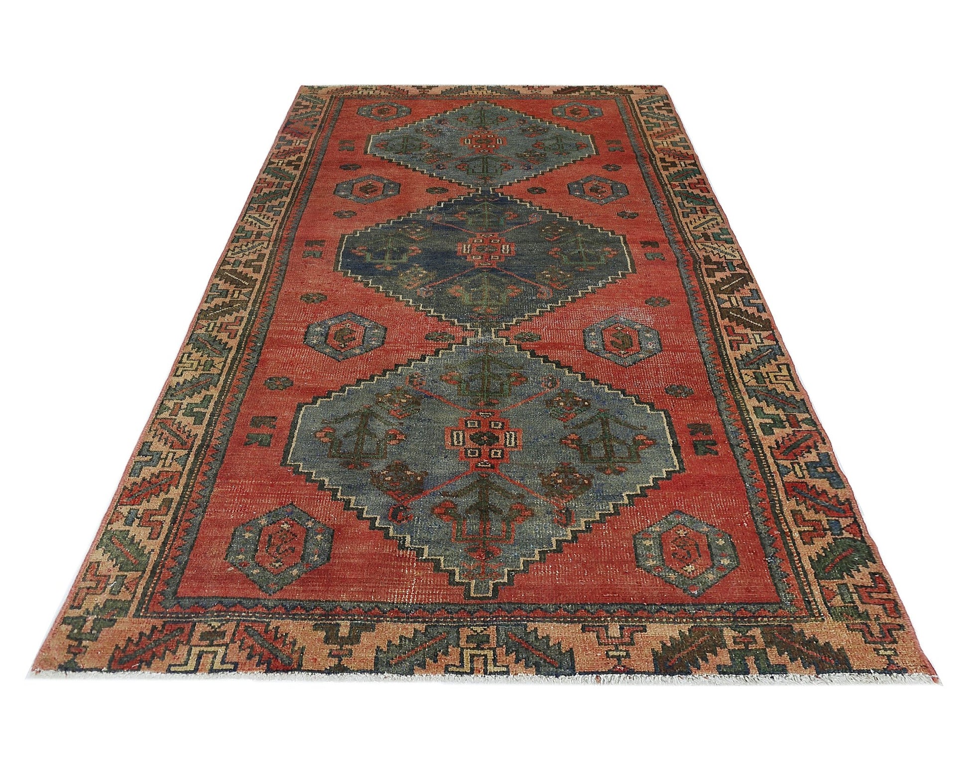A vintage Persian Afshar rug featuring geometric blue medallions on a red field with patterned borders.