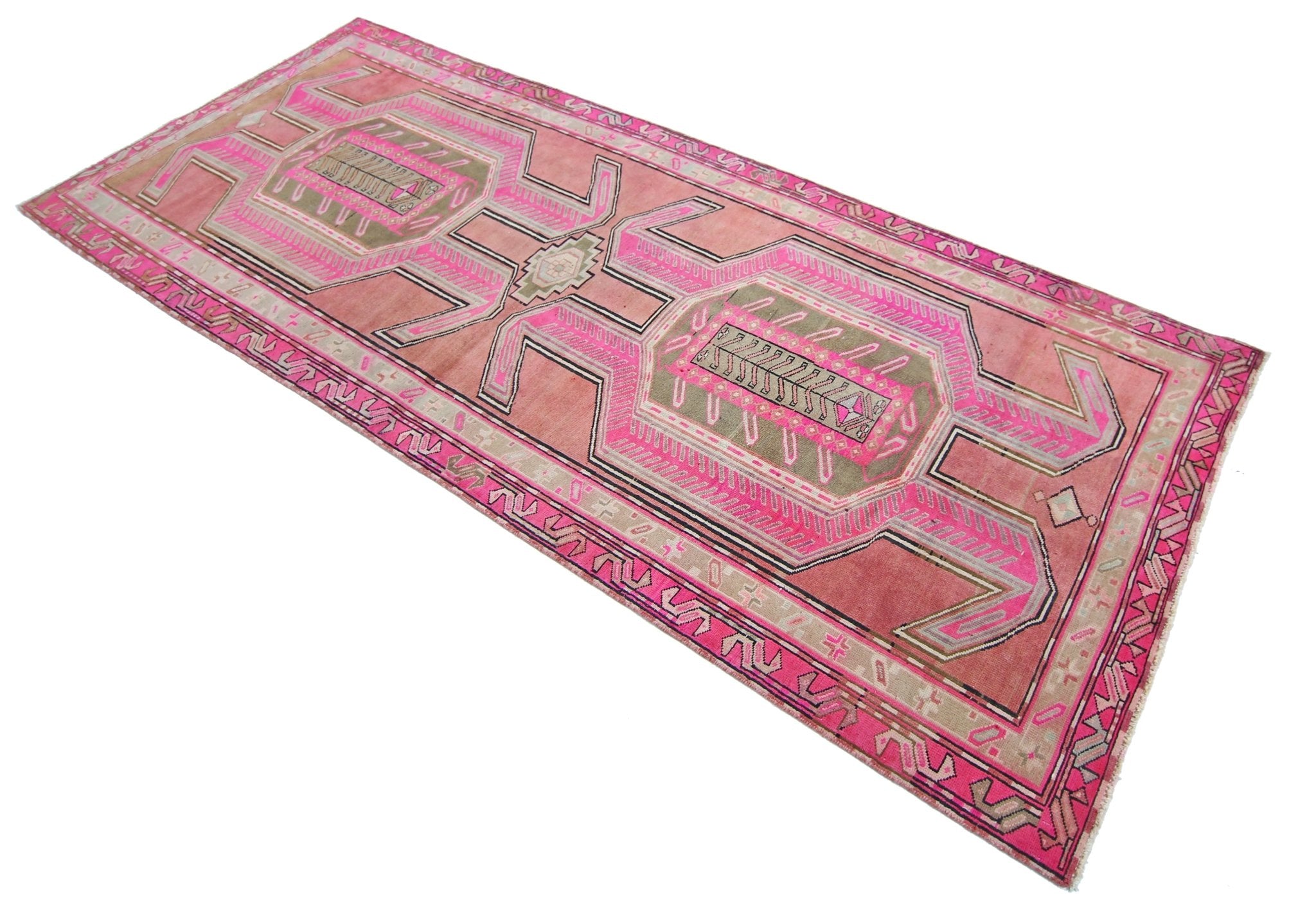 A vintage Persian Ardabil runner rug featuring geometric patterns in shades of pink and olive green.