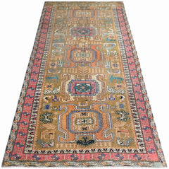 A vintage Persian Ardabil runner rug featuring geometric medallions and animal motifs in tan.