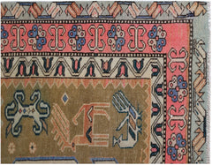 A vintage Persian Ardabil rug featuring geometric animal motifs and floral borders in muted tones.