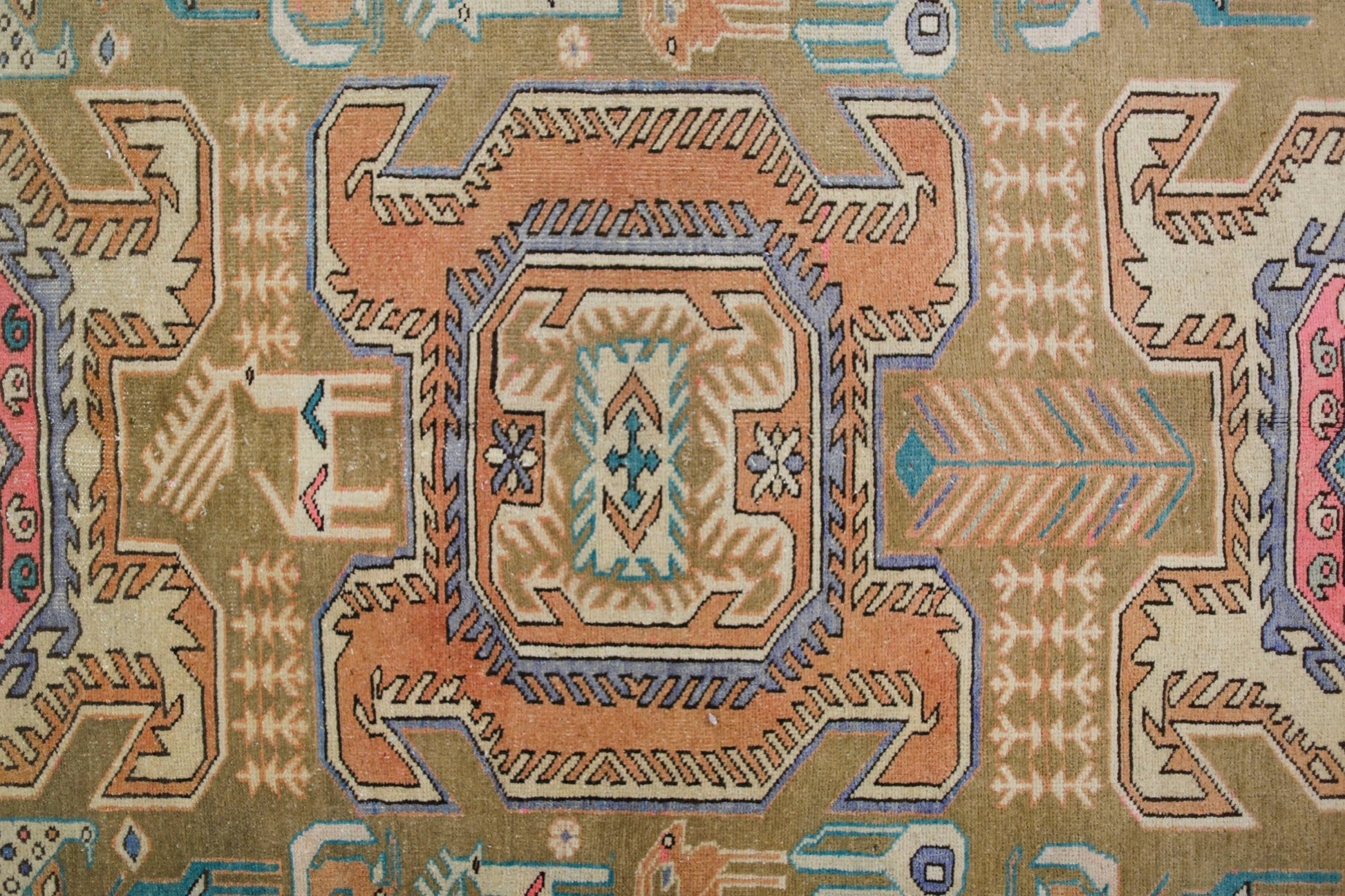 A vintage Persian Ardabil rug featuring a geometric central medallion in orange and blue tones.