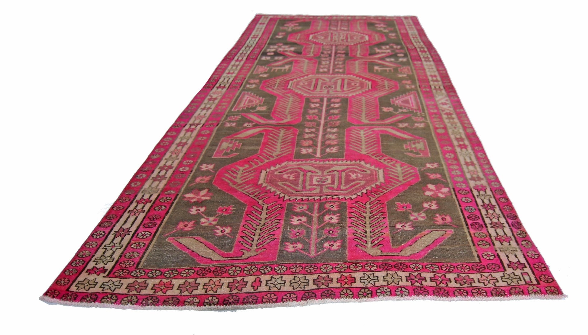 A vintage Persian Ardabil runner rug featuring a geometric pink and brown pattern.