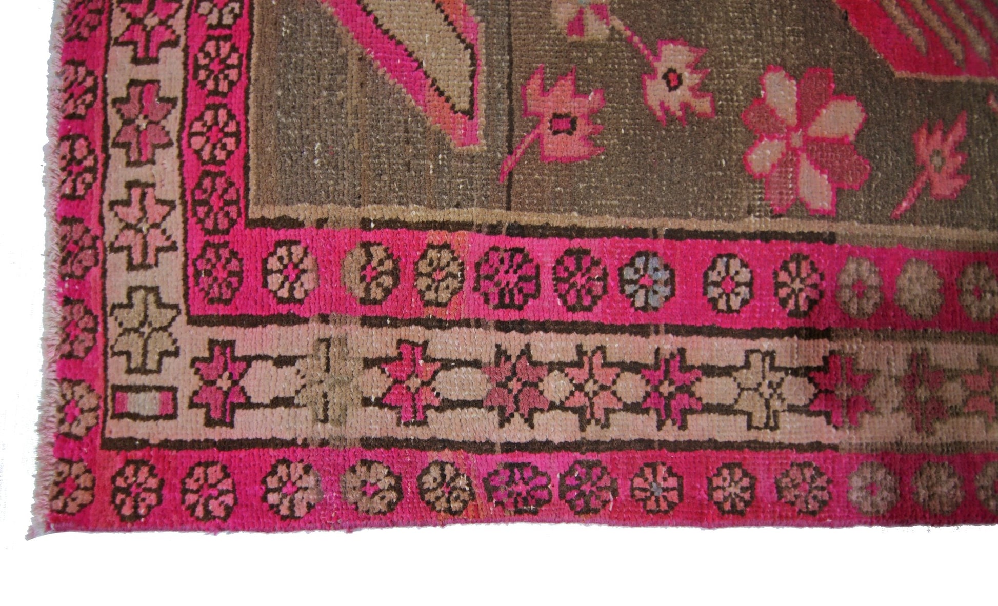 A vintage Persian Ardabil rug featuring a geometric floral border in vibrant pink and brown tones.