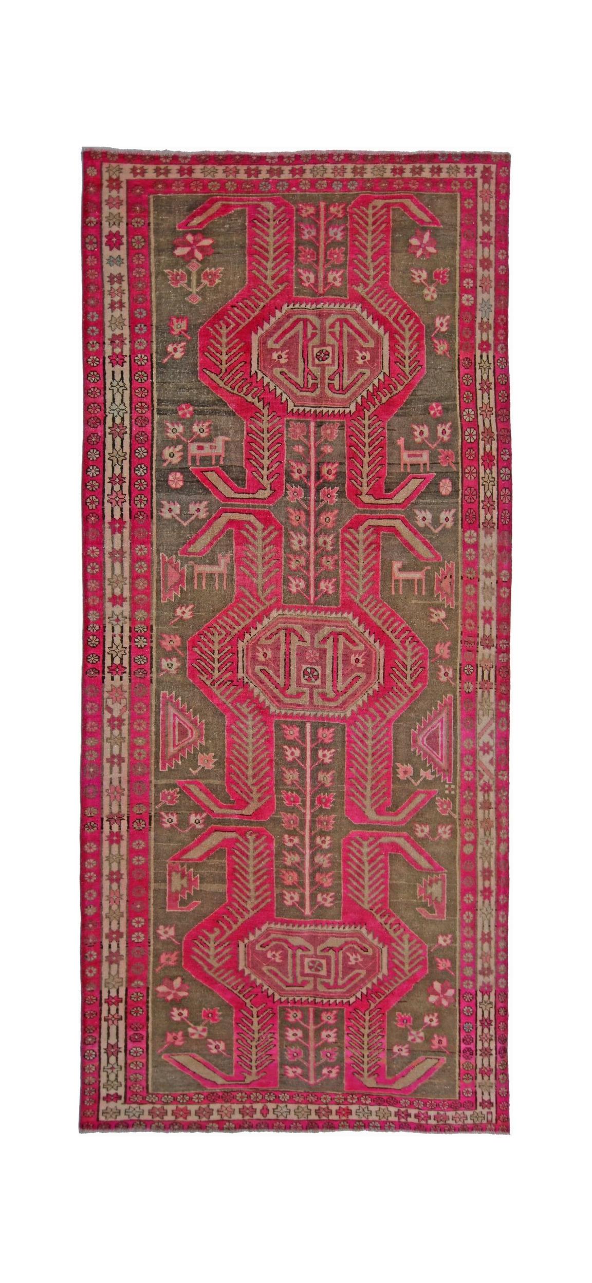 A vintage Persian Ardabil rug featuring a geometric pink and brown pattern on a wool pile.