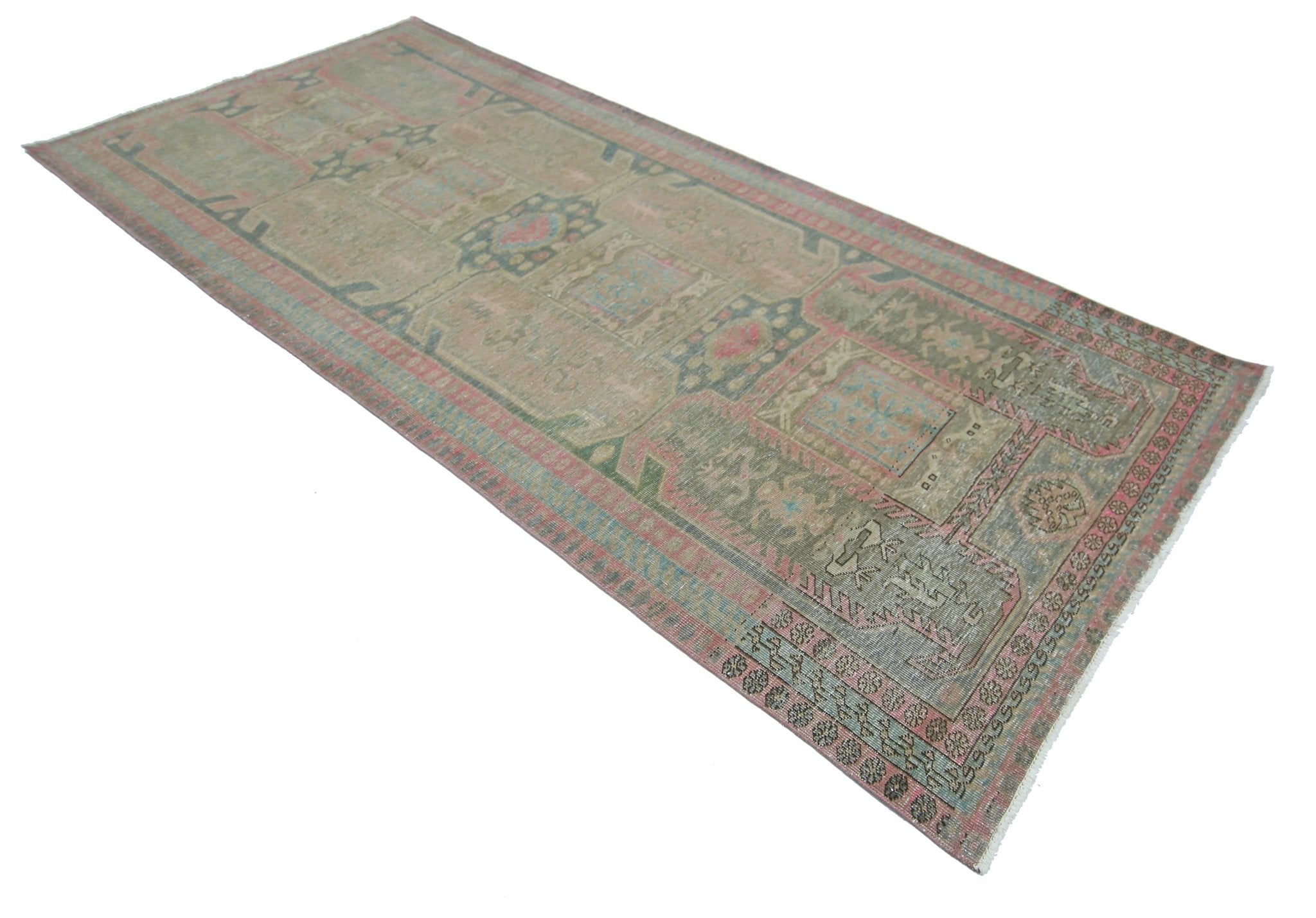 A vintage Persian Ardabil runner rug featuring a faded geometric pattern in muted pink and blue.