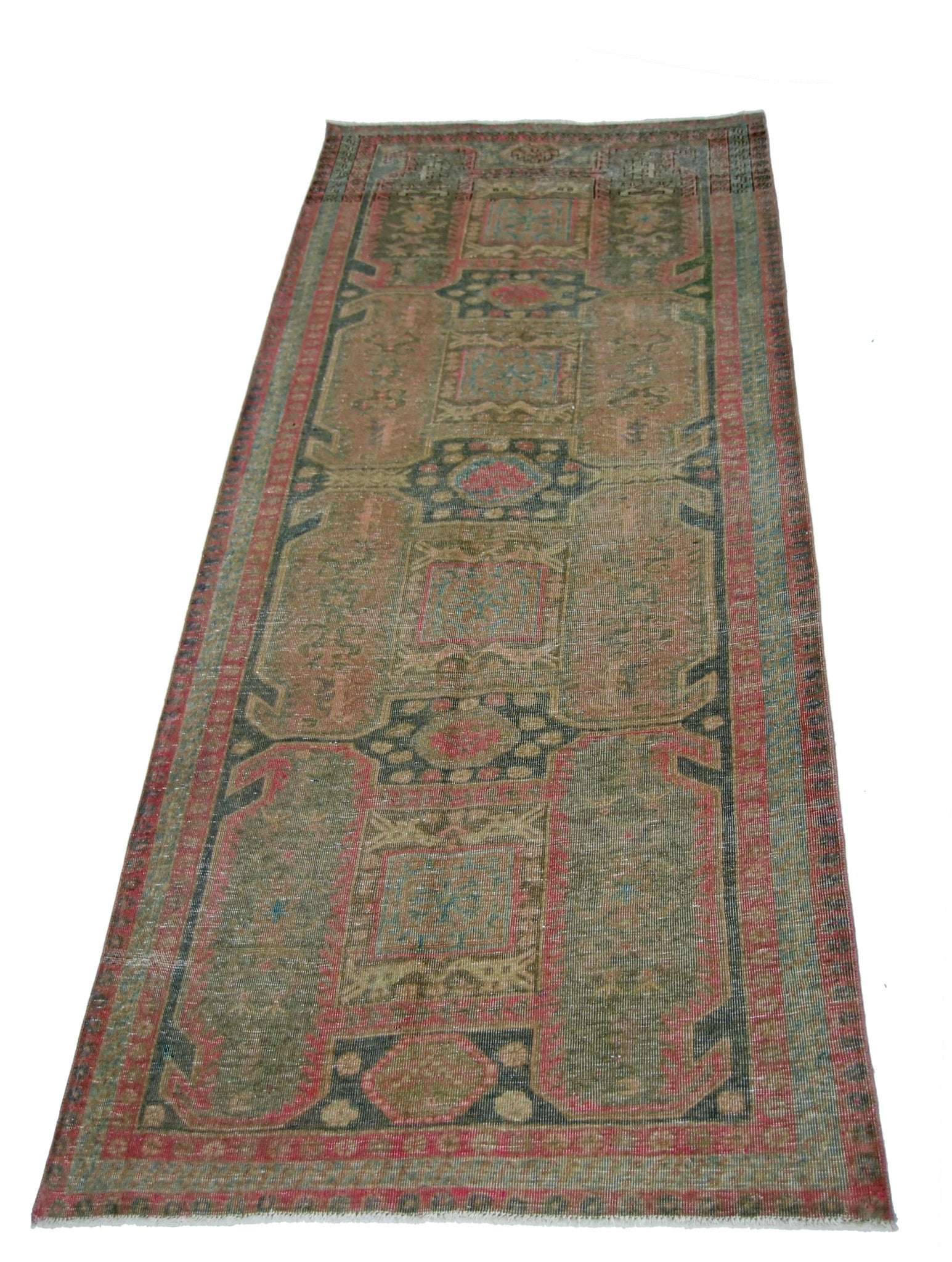 A vintage Persian Ardabil runner rug featuring geometric patterns in muted red, green, and blue.