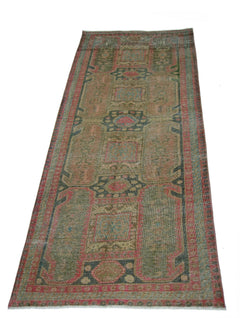 A vintage Persian Ardabil runner rug featuring geometric patterns in muted red, green, and blue.