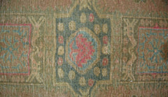 A vintage Persian Ardabil rug featuring a geometric medallion pattern in muted earth tones.