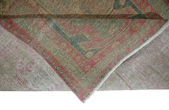 A corner of a vintage Persian Ardabil rug is folded back to show its wool pile and cotton base.