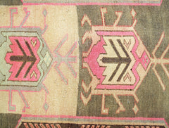 A vintage Persian Ardabil runner featuring geometric medallions in pink, brown, and cream tones.