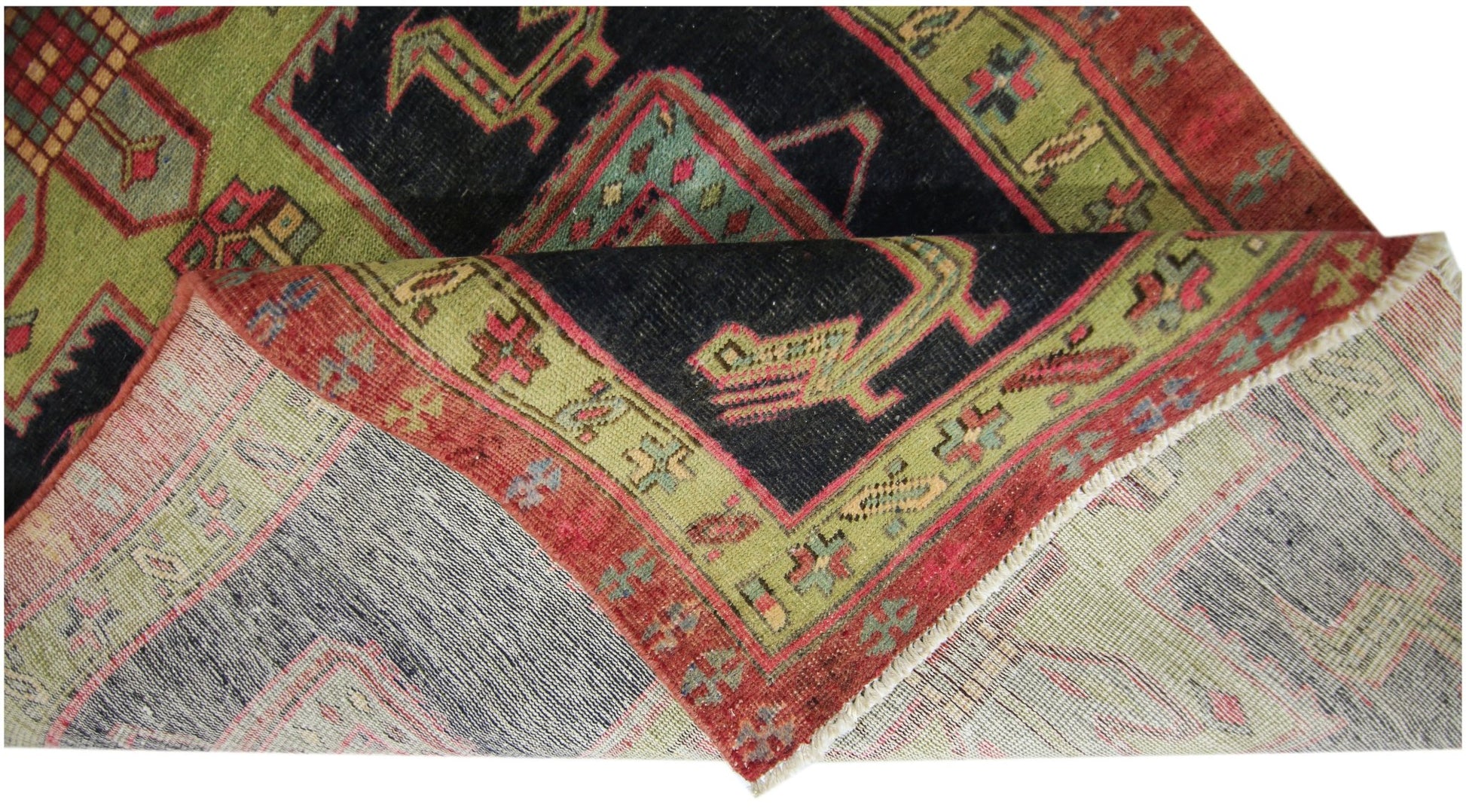 A vintage Persian Ardabil runner with a geometric pattern in red, green, and black wool.