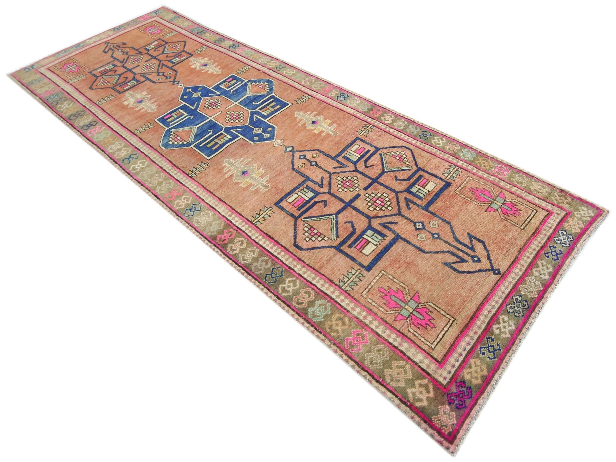 A vintage handmade Persian runner featuring geometric blue motifs on a faded orange background.
