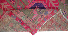 A vintage Persian Ardabil rug with a folded corner revealing its intricate floral pattern.