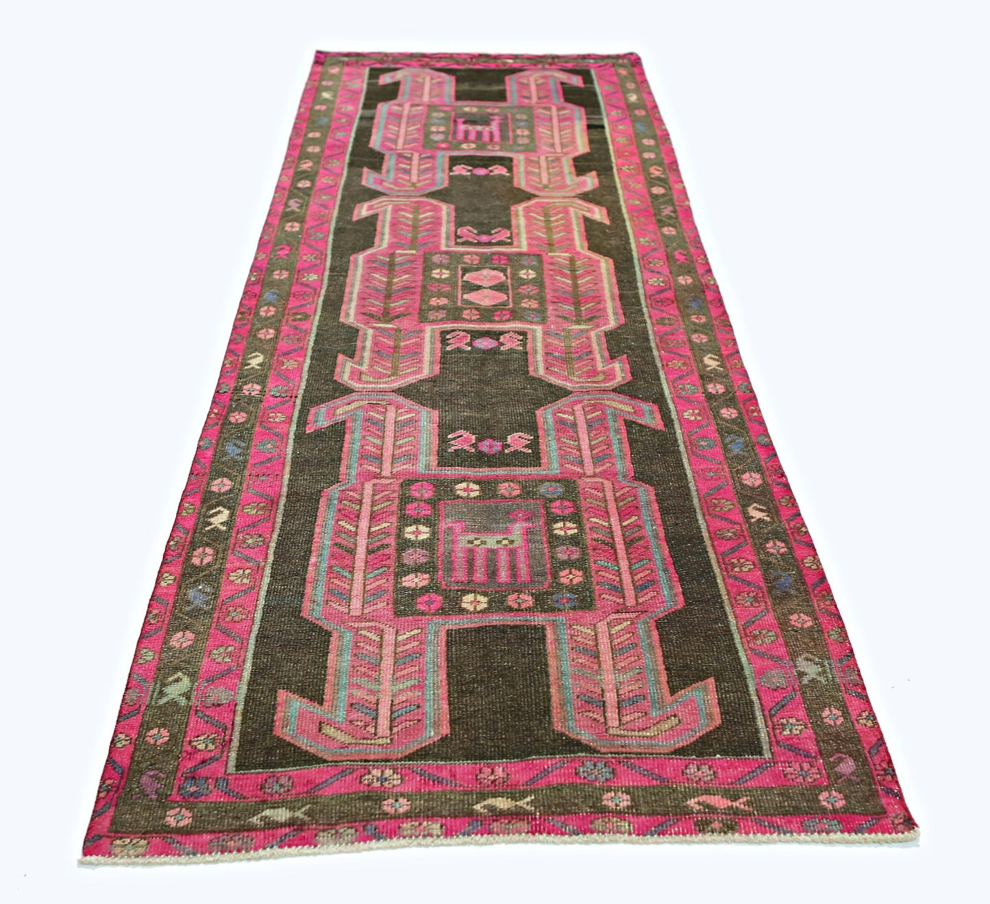 A vintage Persian Ardabil runner featuring geometric pink motifs on a dark brown background.