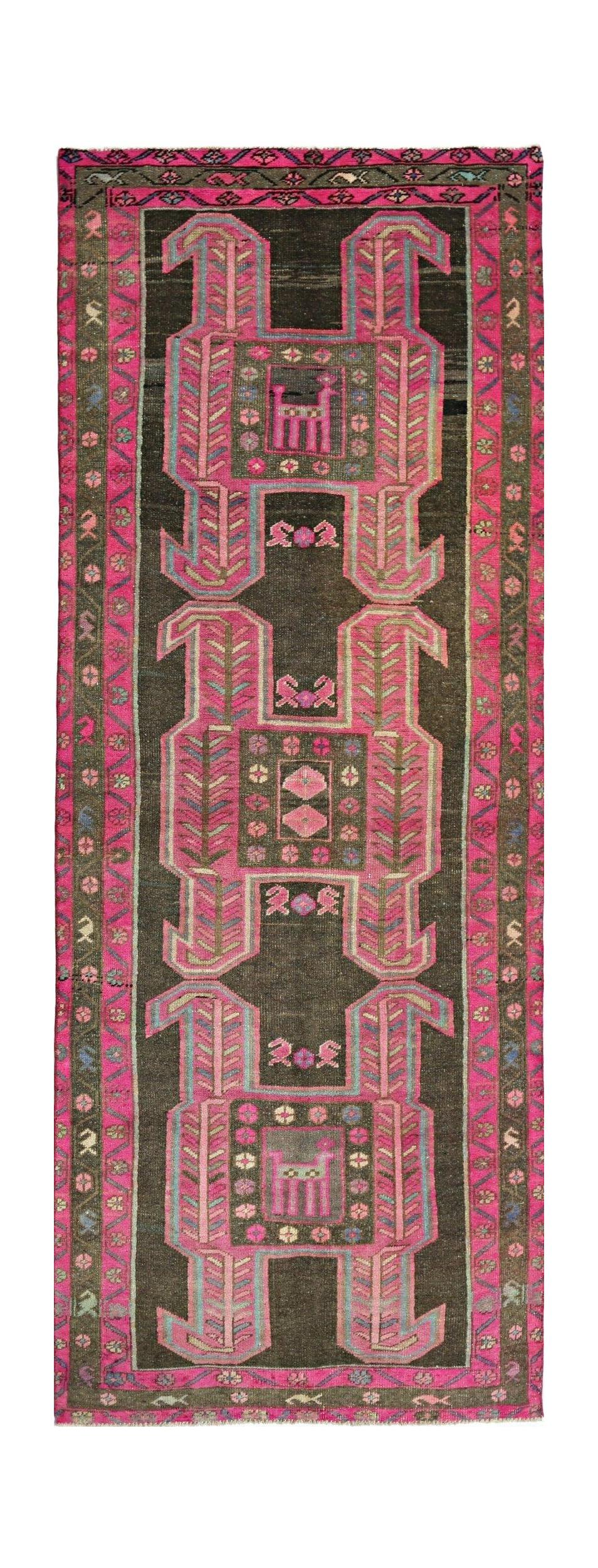 A vintage Persian Ardabil runner featuring a dark brown field with vibrant pink geometric motifs.