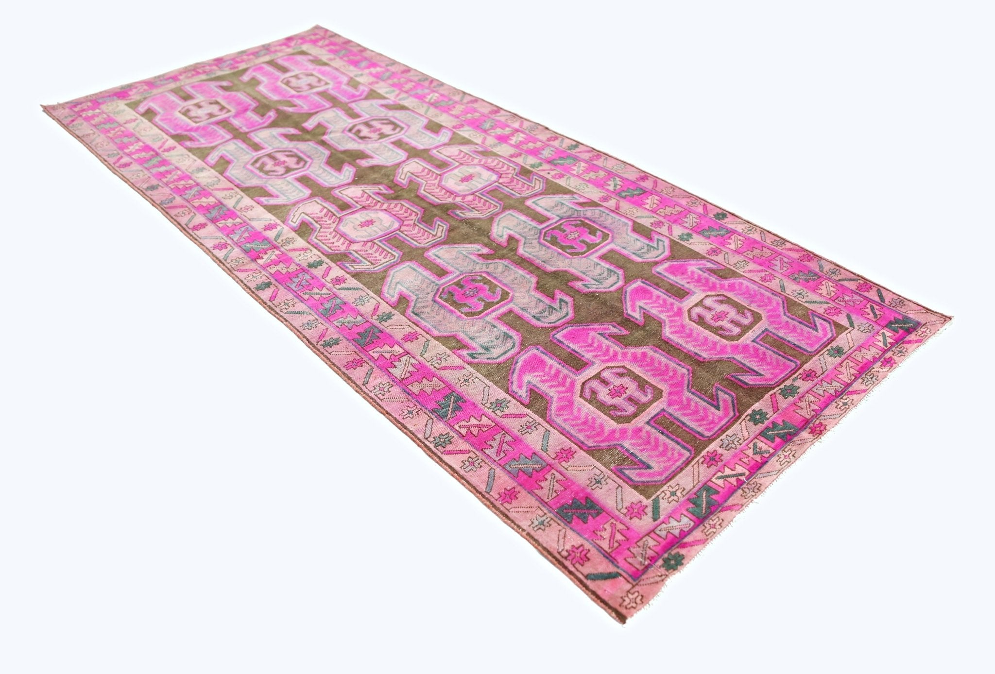 A vintage Persian Ardabil runner featuring geometric patterns in vibrant pink and brown tones.