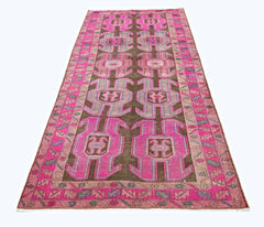 A vintage Persian Ardabil runner featuring a dark brown field with vibrant pink geometric motifs.