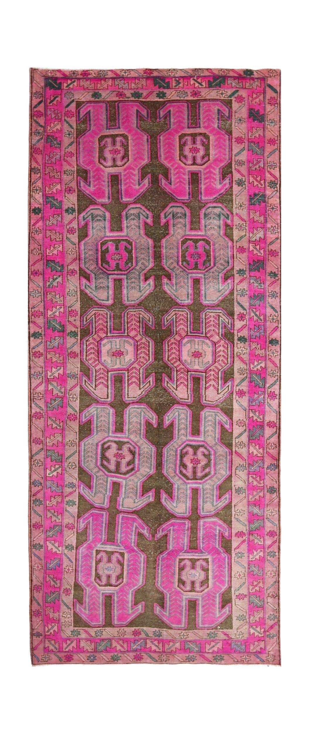 A vintage Persian Ardabil runner featuring a dark brown field with repeating pink geometric motifs.